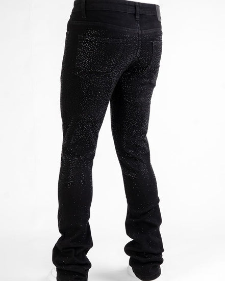 Black jeans with rhinestone embellishments on a white background