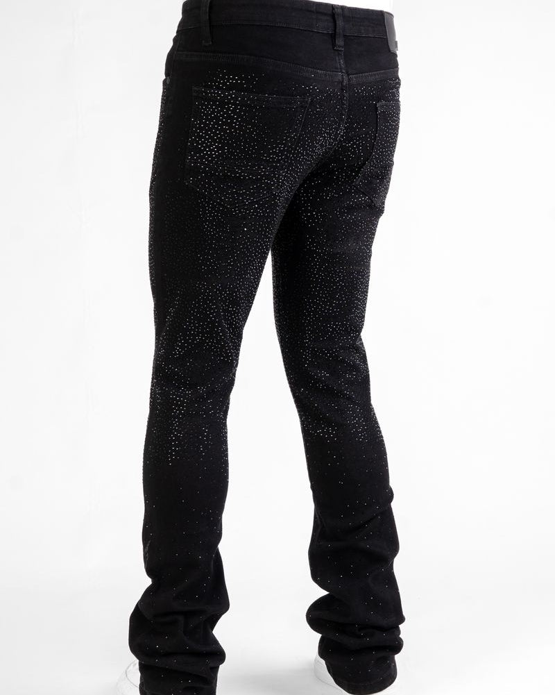 Black jeans with rhinestone embellishments on a white background