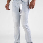 Light blue jeans with a brand tag held by a person on a white background