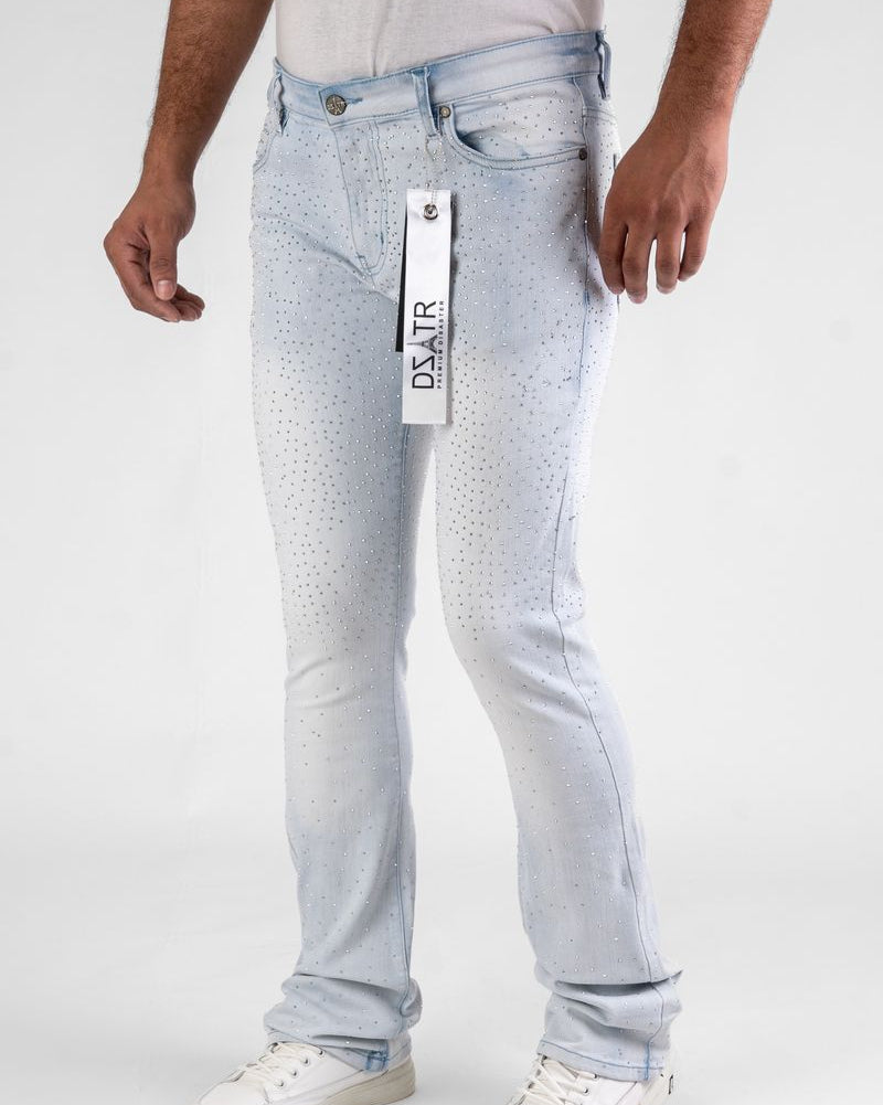 Light blue jeans with a brand tag held by a person on a white background