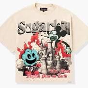 A cream-colored graphic t-shirt featuring a stylized Mickey Mouse design with the text 'Sugarhill' and 'The Most Magical Place on Earth'. The graphic includes a castle, red flames, and a blue character, set against a light gray background.