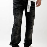 Person wearing black distressed jeans with a white label on a white background