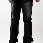 Person wearing black jeans on a white background