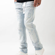 Person wearing light blue jeans with brand label on a white background