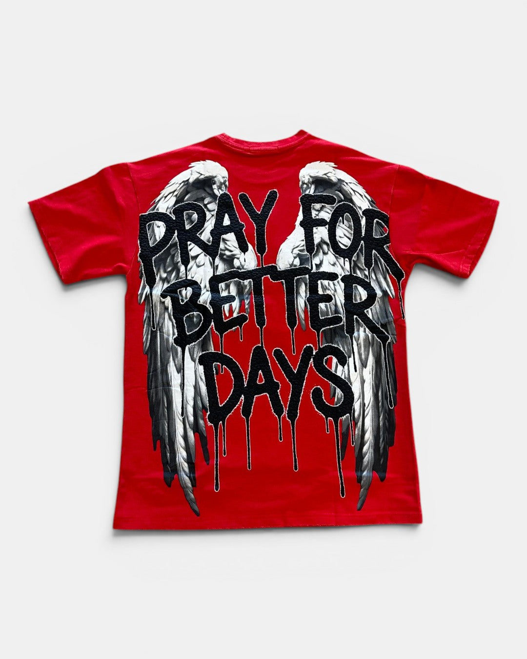 Red t-shirt with black text 'Pray for Better Days' and wings on a white background