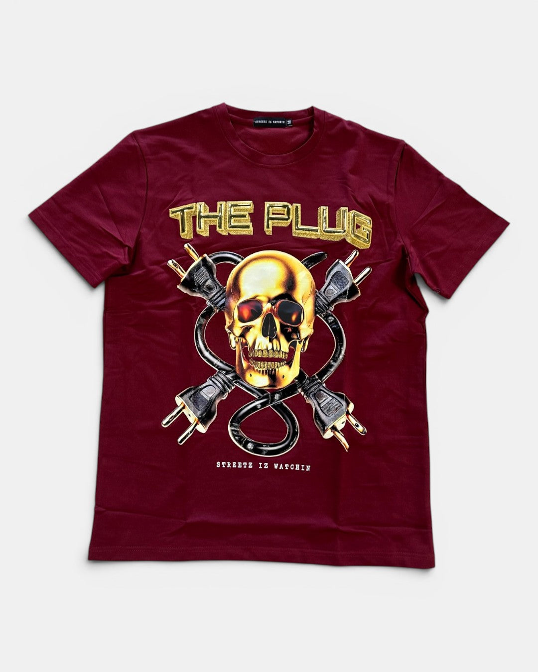 Maroon t-shirt with a graphic design of a skull and power plugs on a white background