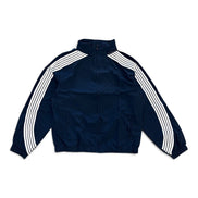 A navy blue track jacket with three white stripes running down the sleeves, laid flat against a white background.