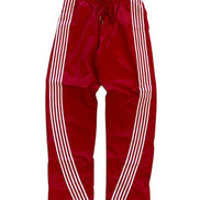 Red track pants with white stripes on a white background