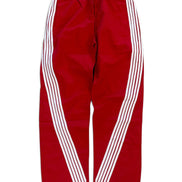 Red track pants with white diagonal stripes running down the sides, featuring an elastic waistband and drawstring.