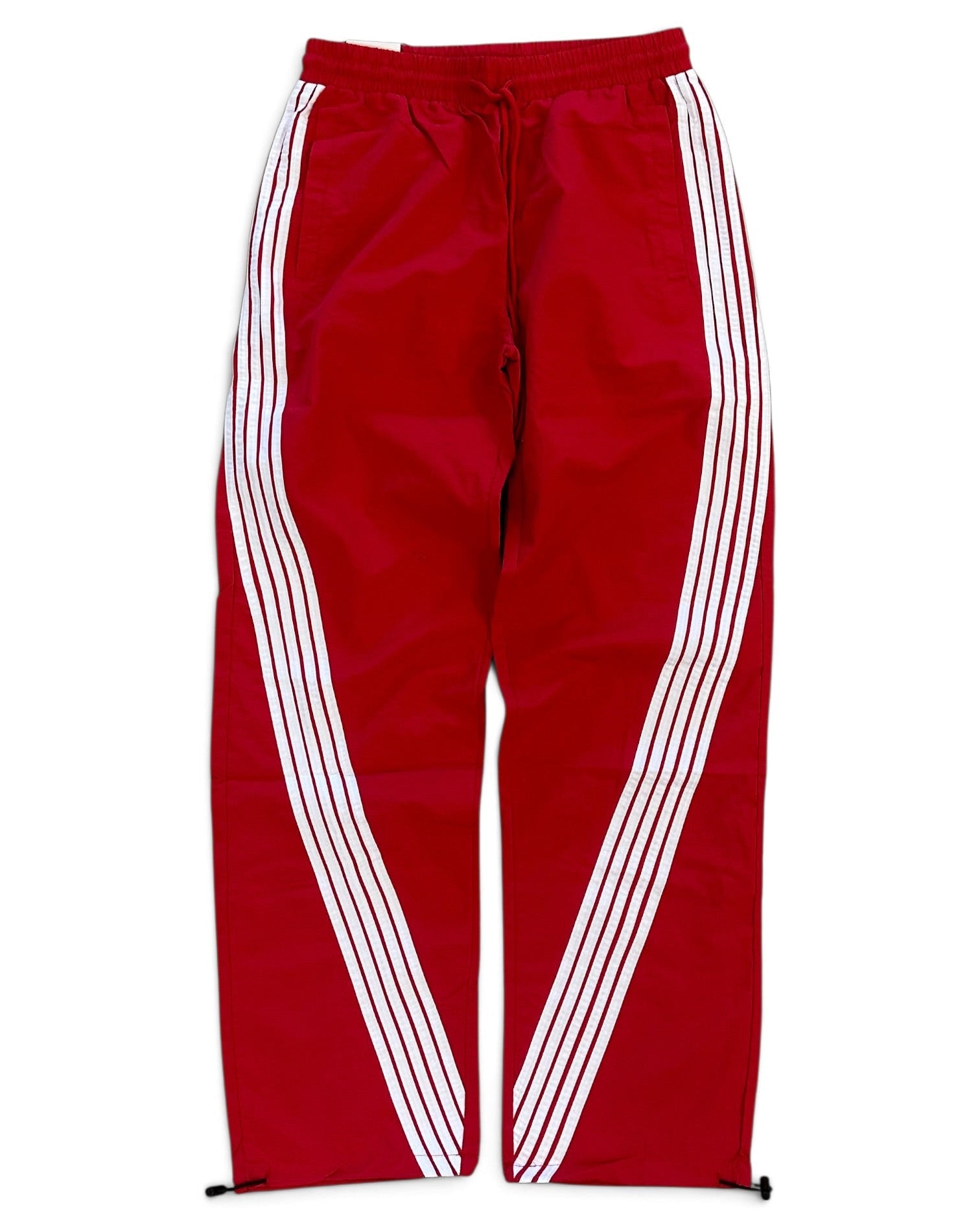 Red track pants with white diagonal stripes running down the sides, featuring an elastic waistband and drawstring.