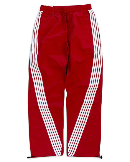 Red track pants with white diagonal stripes running down the sides, featuring an elastic waistband and drawstring.