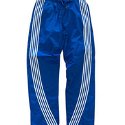Blue track pants with white stripes on a white background