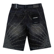 Black denim shorts with speckled pattern on a white background