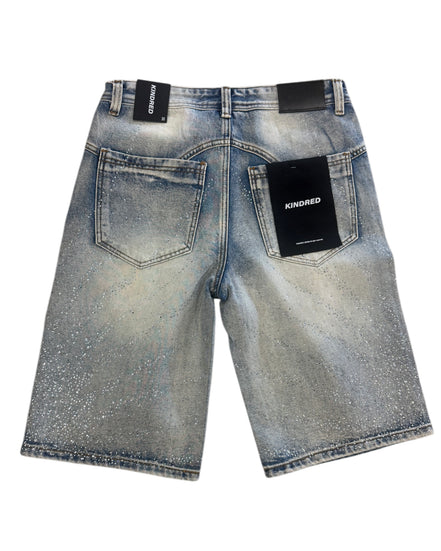 Blue denim shorts with 'Kindred' branding on a white background