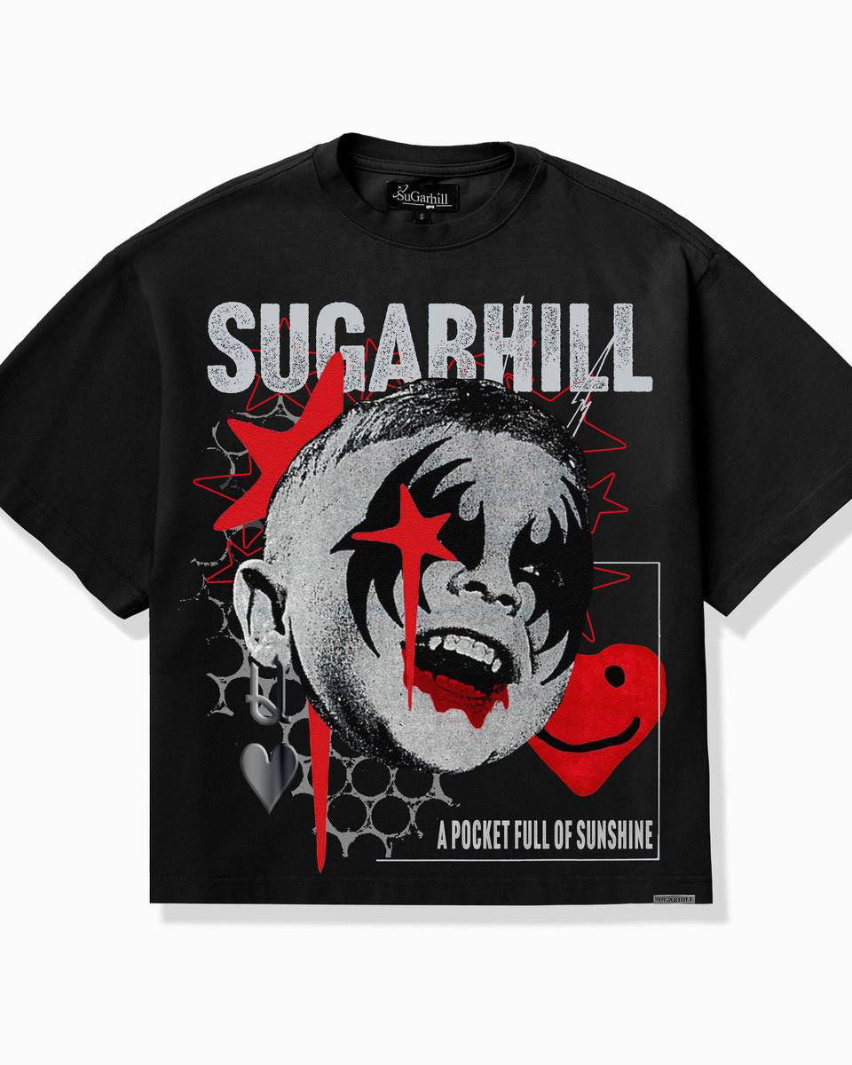 A black short-sleeve graphic t-shirt featuring a stylized clown face with red paint details, the word 'SUGARHILL' in distressed white letters, and a red smiley face on the front.