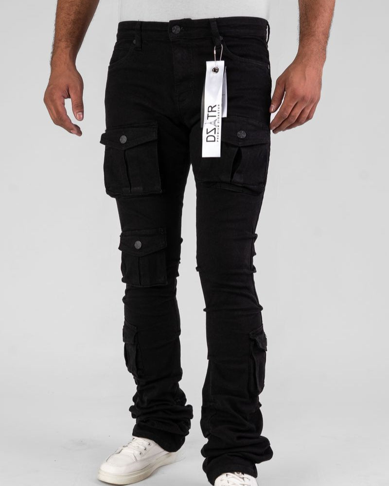 Person wearing black cargo pants with a brand tag on a white background
