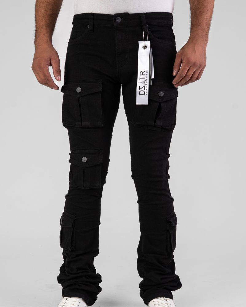 Person wearing black cargo pants with a visible brand tag on a gray background