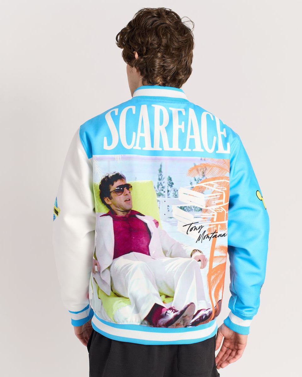 Person wearing a 'Scarface' themed jacket with a graphic of a man in sunglasses and a car.