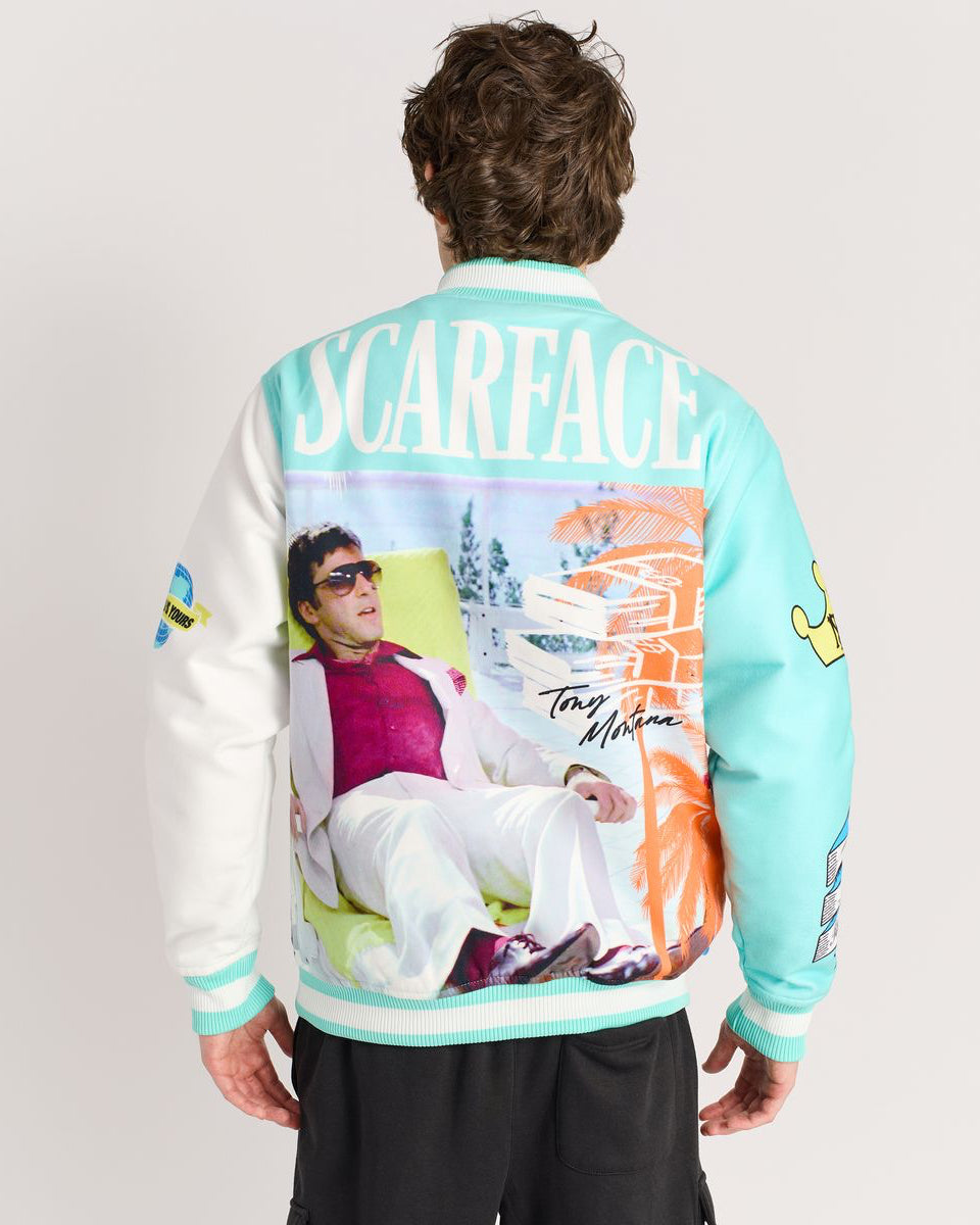 Person wearing a colorful jacket with 'Scarface' design on the back