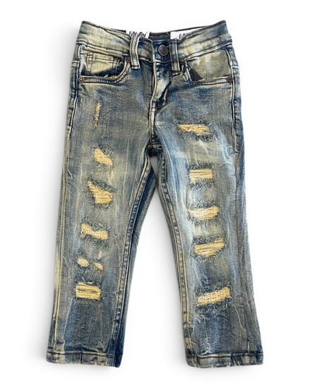 Distressed blue jeans on a white background