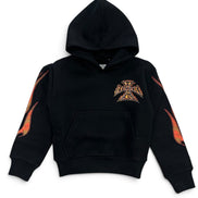 A black cropped pullover hoodie featuring a stylized metallic gold and orange Iron Cross emblem on the left chest, with matching flame-like graphic prints on both sleeves.