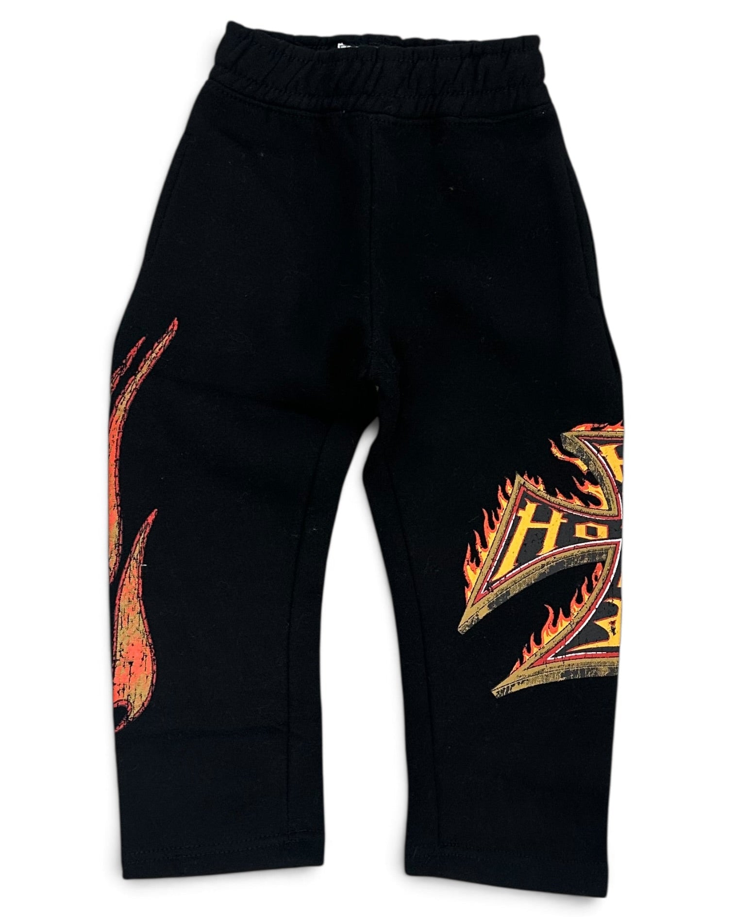 Black sweatpants with orange and yellow flame graphics on the left leg and right leg, featuring an elastic waistband.