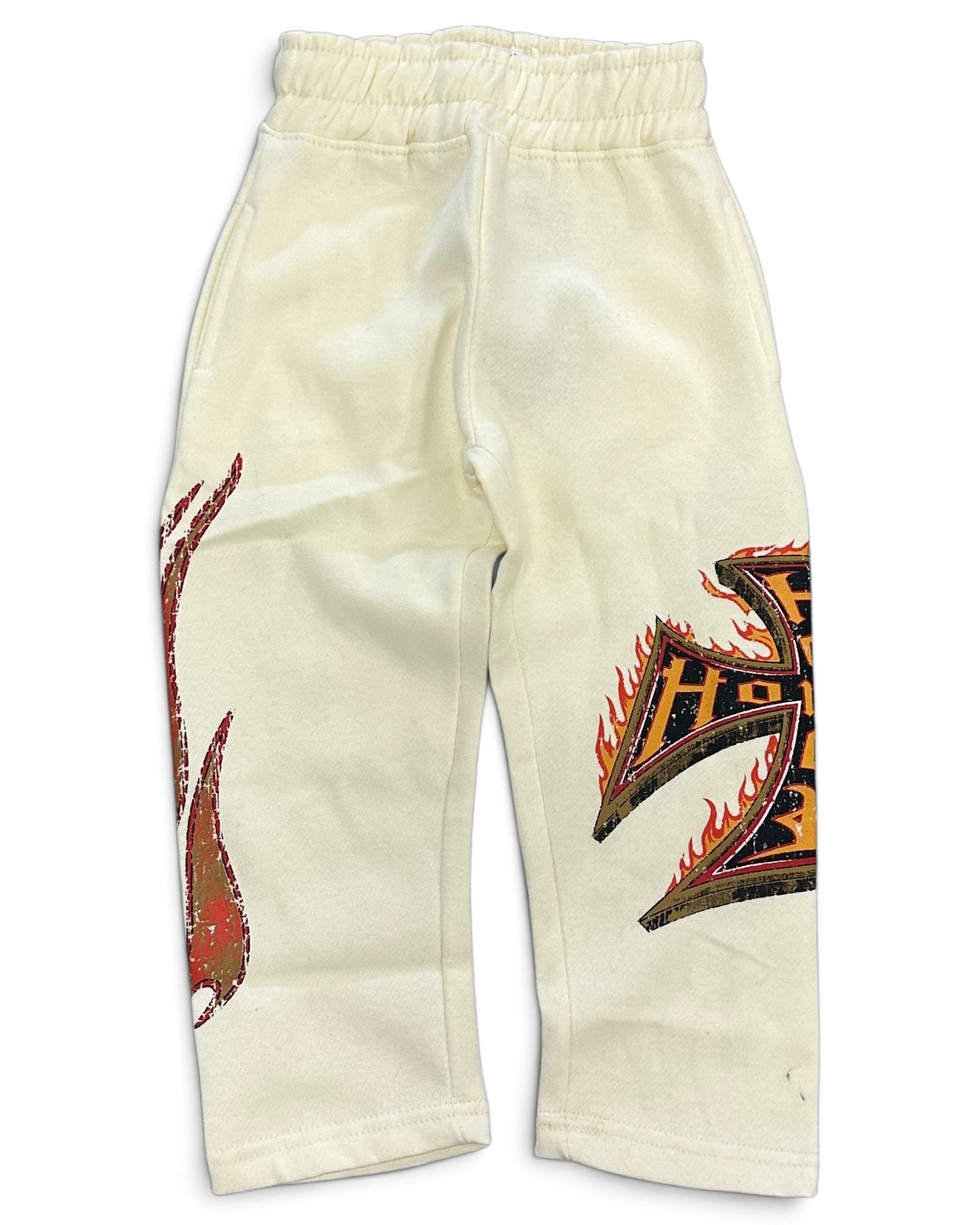 Off-white sweatpants featuring a red and black flame graphic on the left leg and a large black and orange graphic with red flame details on the right leg, displayed flat against a white background.