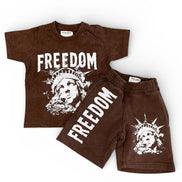 Brown children's t-shirt and shorts set with 'Freedom' text and graphic design on a white background