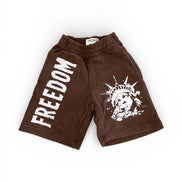 Brown shorts with 'FREEDOM' text and graphic design on a white background