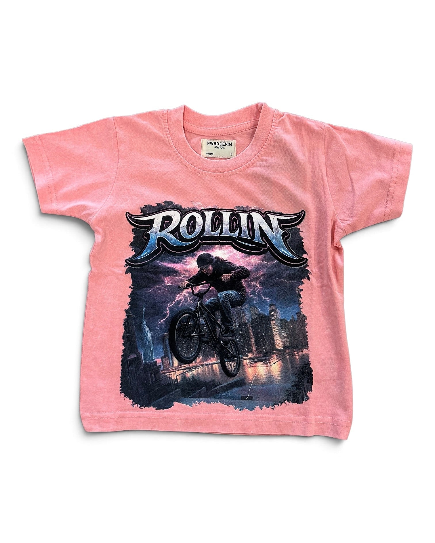 A pink short-sleeve kids' t-shirt featuring a large graphic print of a mountain biker in mid-air with the word 'ROLLIN' in stylized lettering above, set against a plain white background.