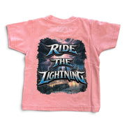 A pink short-sleeve t-shirt with a large graphic print on the back featuring the text 'RIDE THE LIGHTNING' in stylized metallic lettering over a dark stormy sky and lightning scene.