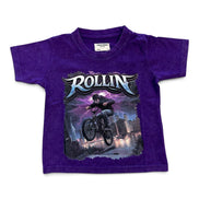 A purple short-sleeve kids' t-shirt featuring a large graphic print of a BMX rider with the word 'ROLLIN'' in stylized lettering, displayed flat against a white background.
