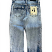 Back view of a pair of light blue denim jeans with a distressed and splattered wash, featuring a paper brand tag on the back pocket.