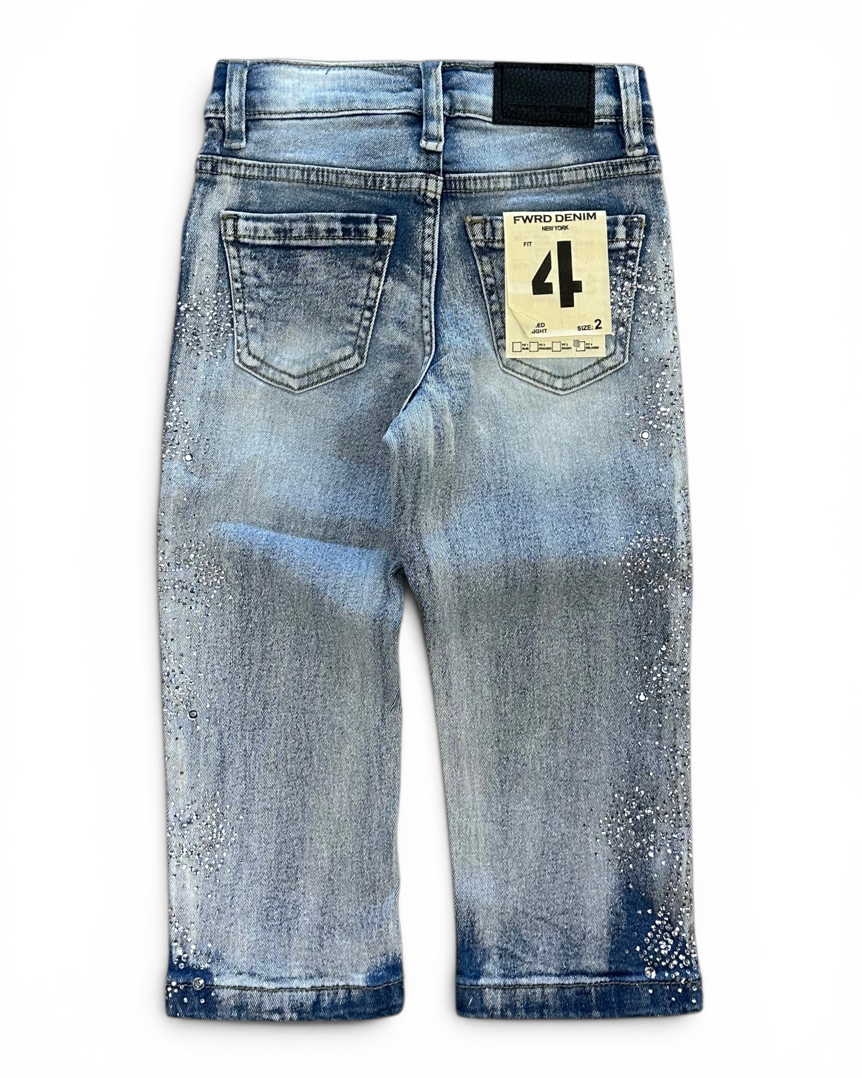 Back view of a pair of light blue denim jeans with a distressed and splattered wash, featuring a paper brand tag on the back pocket.