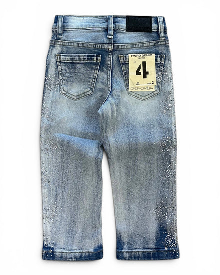Back view of a pair of light blue denim jeans with a distressed and splattered wash, featuring a paper brand tag on the back pocket.