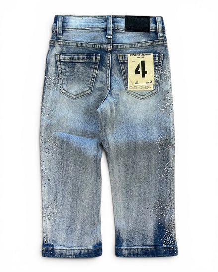 Back view of a pair of light blue denim jeans with a distressed and splattered wash, featuring a paper brand tag on the back pocket.