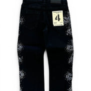 Black denim pants with white rhinestone embellishments on the outer thighs, shown from the back with a size 4 paper tag attached.