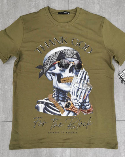 Green t-shirt with a skeleton graphic and text on a gray surface