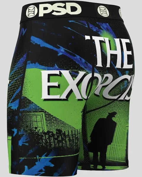 Shorts with 'The Exorcist' design and 'PSD' branding on a gray background