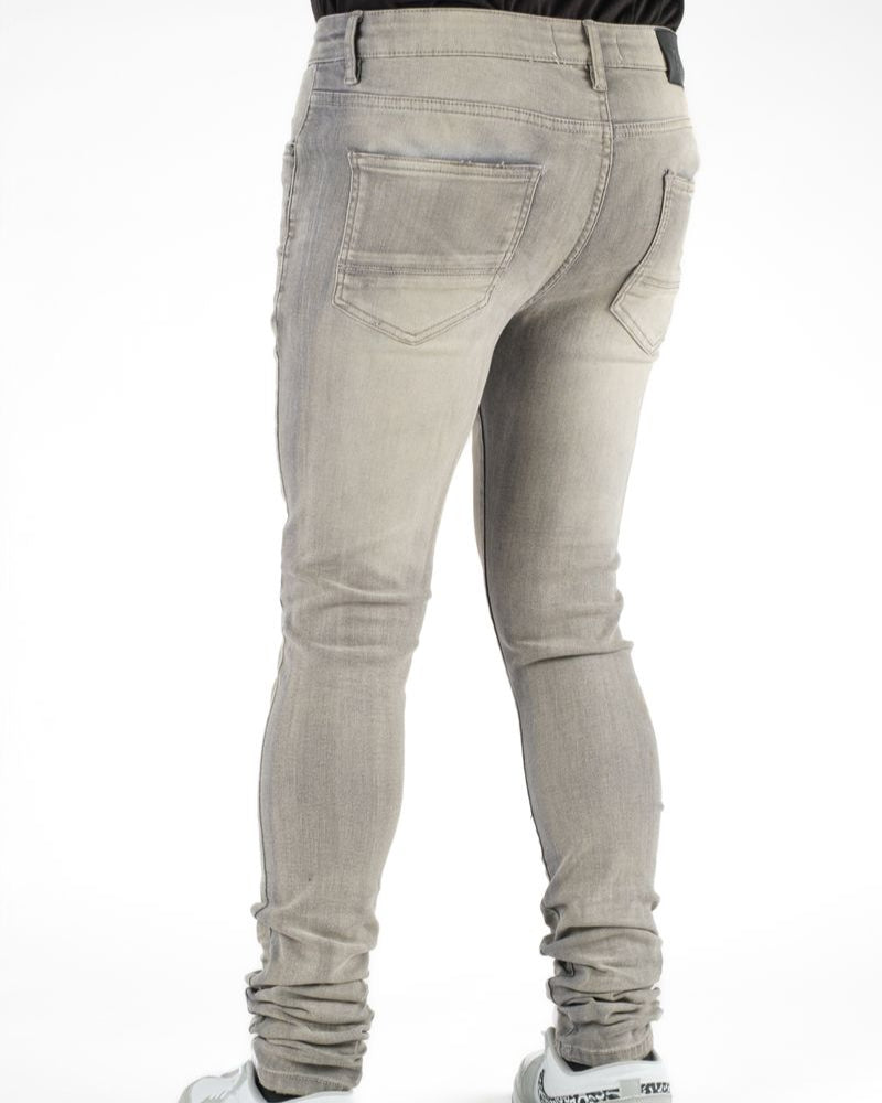 Light gray jeans worn by a person on a white background
