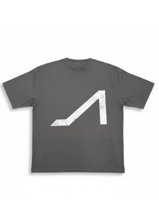 A dark gray crewneck t-shirt featuring a large, distressed white geometric logo on the front, displayed against a clean white background.