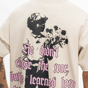 Person wearing a white t-shirt with a graphic design and text on the back.