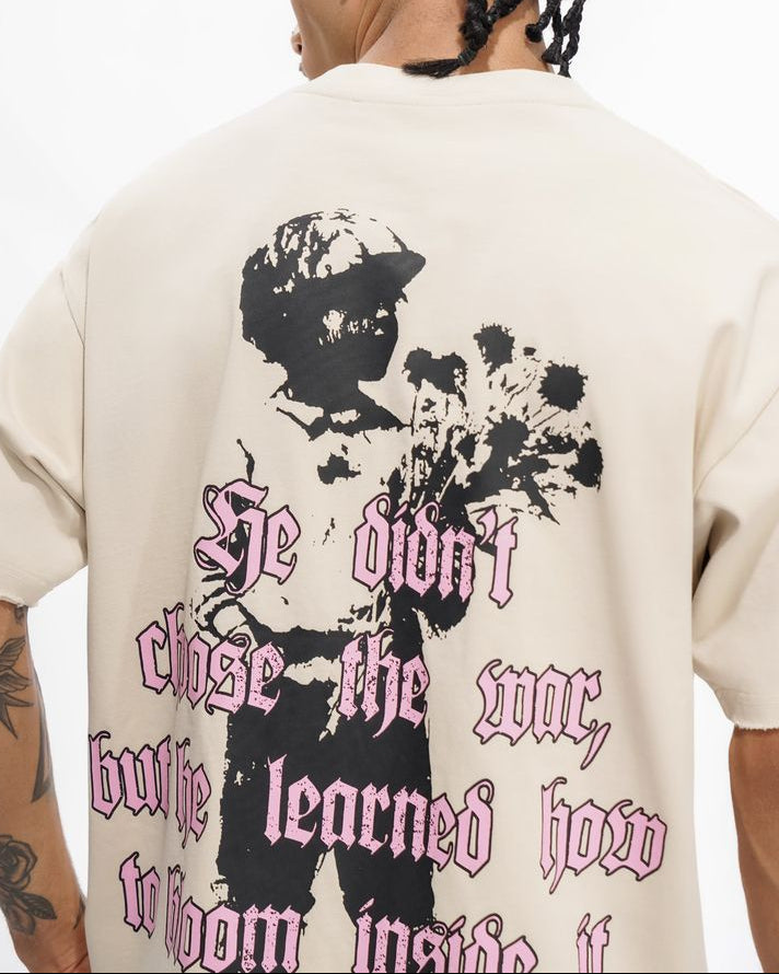 Person wearing a white t-shirt with a graphic design and text on the back.