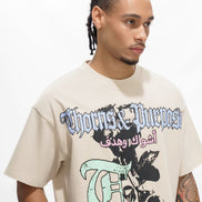 Man wearing a 'Thorns & Purposes' t-shirt with graphic design on a white background