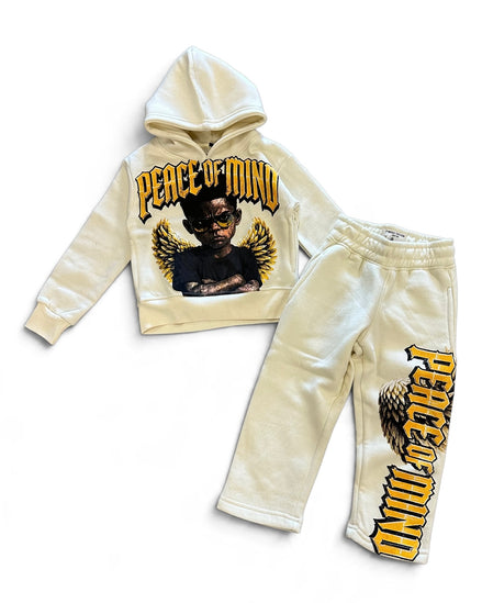 A two-piece kids' sweatshirt and jogger set in cream/off-white. The hoodie features a graphic of a winged angel with the text 'PEACE OF MIND' in yellow and black.