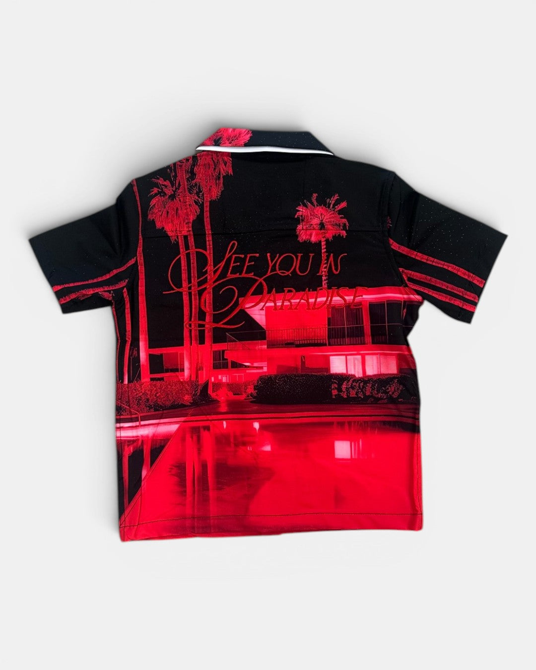 Black and red shirt with palm tree design and text on a white background