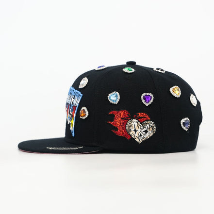 Black cap with colorful embellishments on a white background