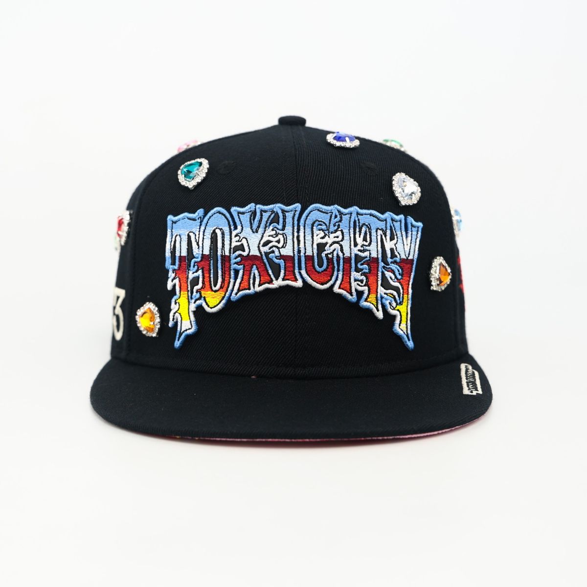 Black cap with colorful 'TOXICITY' text and graphics on a white background