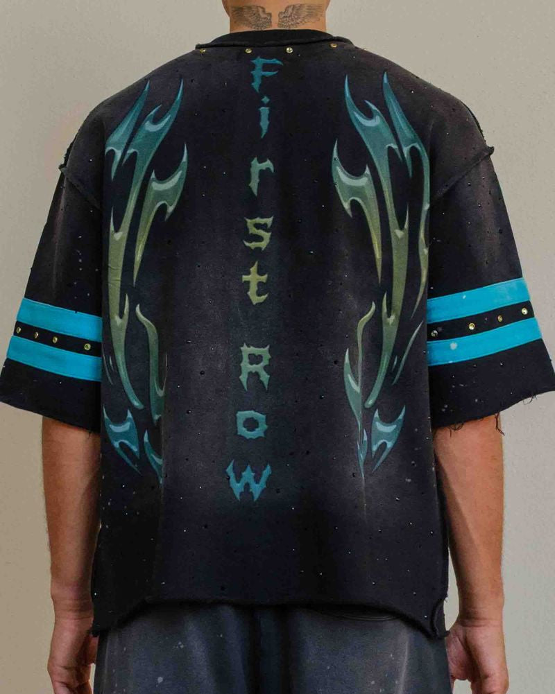 Black t-shirt with blue flame designs and text on a plain background