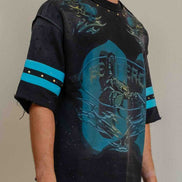 Person wearing a black and blue graphic t-shirt with matching pants on a plain background